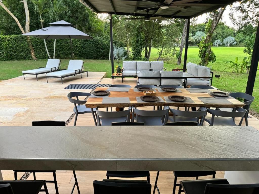 - une table et des chaises en bois sur la terrasse dans l'établissement Casa Privada en Exclusivo Club Privado, à Ricaurte