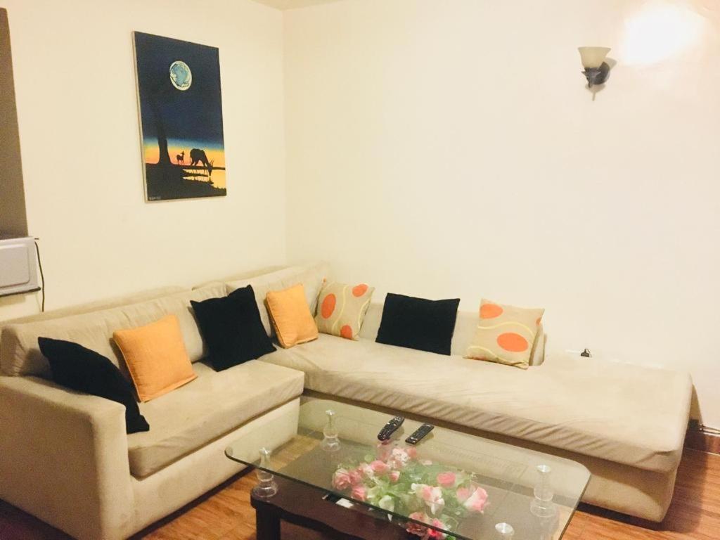 a living room with a couch and a coffee table at Waridi Apartments in Nairobi