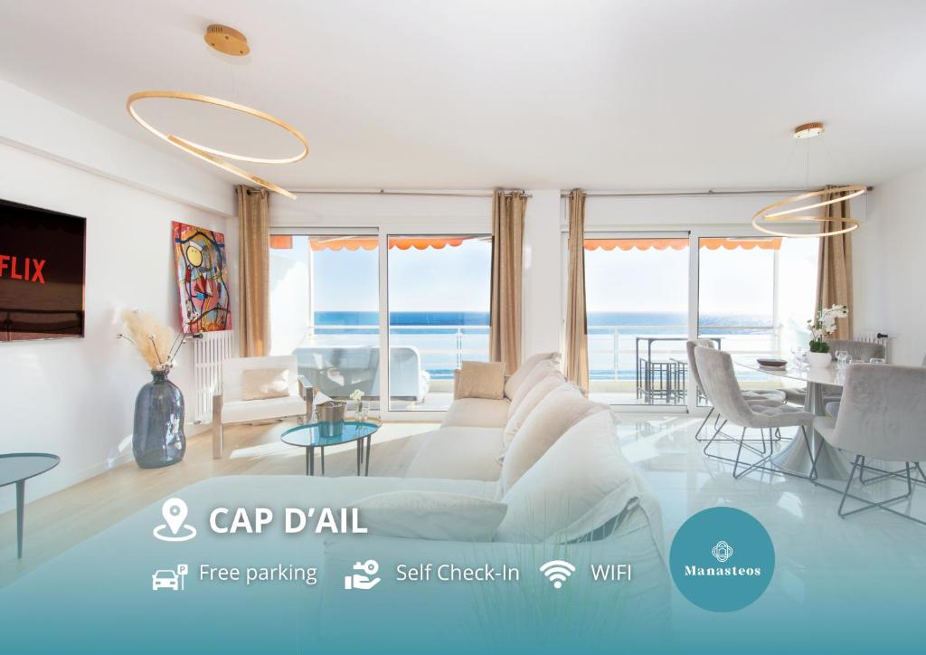 een woonkamer met een bank en een tafel bij Close to Monaco - Amazing Bay View - Free Parking in Saint-Antoine