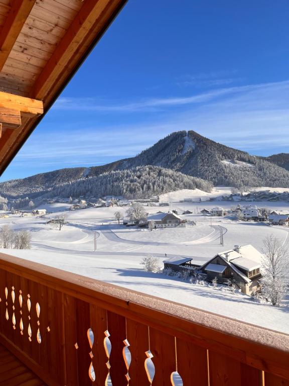 a view of a snowy mountain from a deck at Apartment Tanzberger in Faistenau