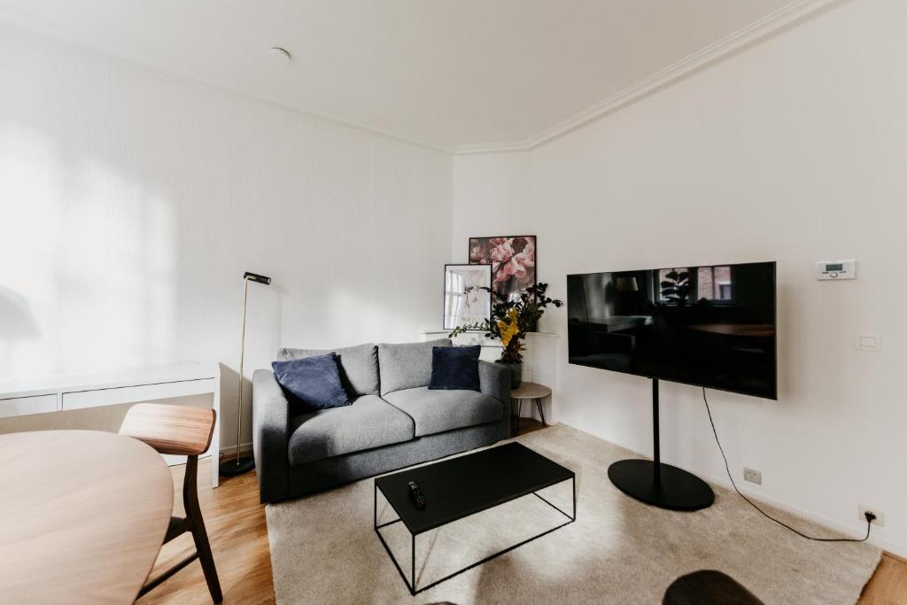 a living room with a couch and a tv at Cathedral view apartment in Antwerp