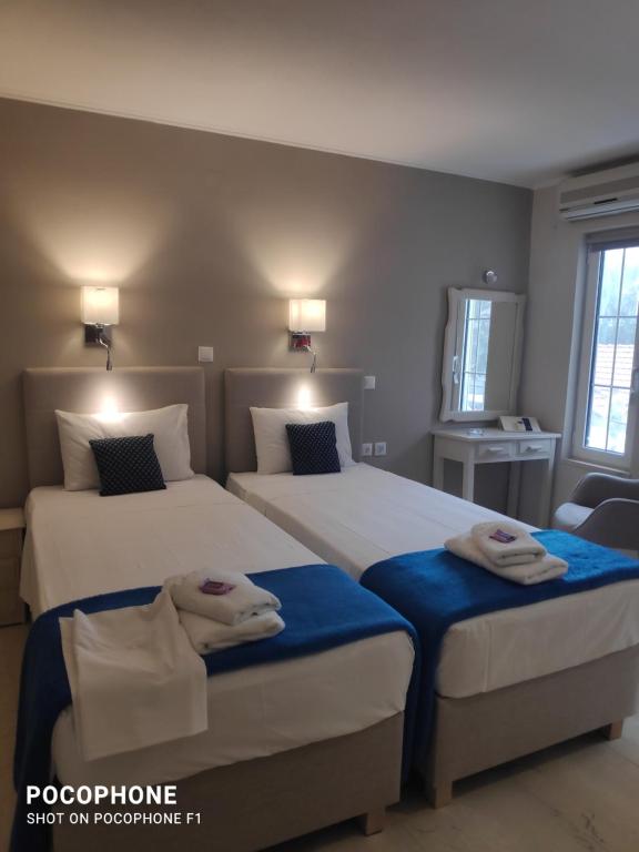 a bedroom with two beds with blue sheets at Villa Katerina in Chania Town