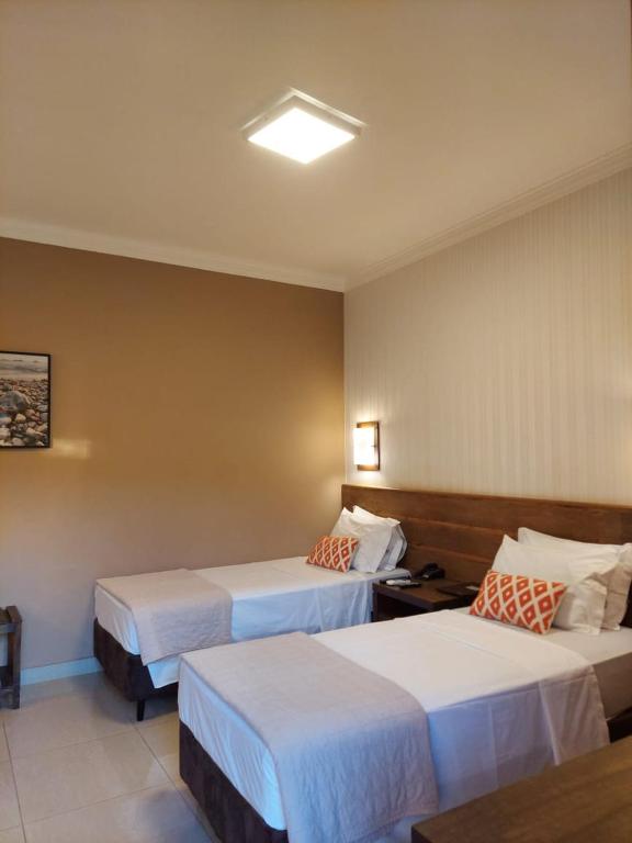 Postel nebo postele na pokoji v ubytování Hotel Pousada Santa Rita