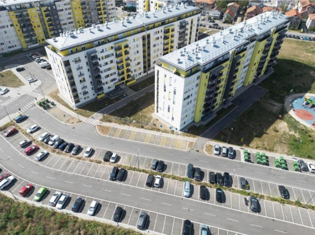 an overhead view of a large building with cars in a parking lot at MoonZE apartman, free parking in Novi Grad