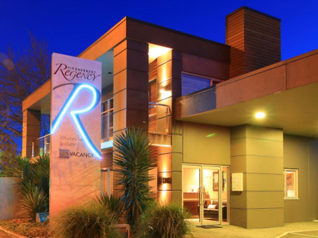 a building with a rx sign in front of it at Fitzherbert Regency Motor Lodge in Palmerston North