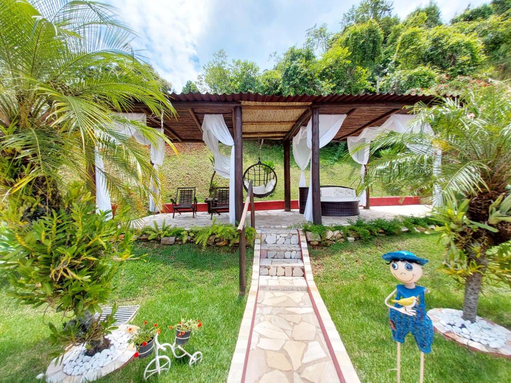 a house with a garden with a statue in the yard at Pousada Pompeia in Socorro