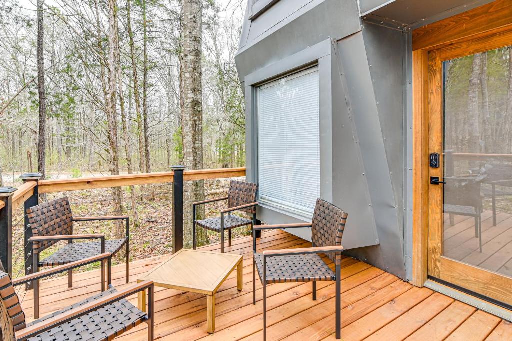 a deck with chairs and a table and a window at Modern and Cozy Starkville Studio about 2 Mi to MSU! in Starkville