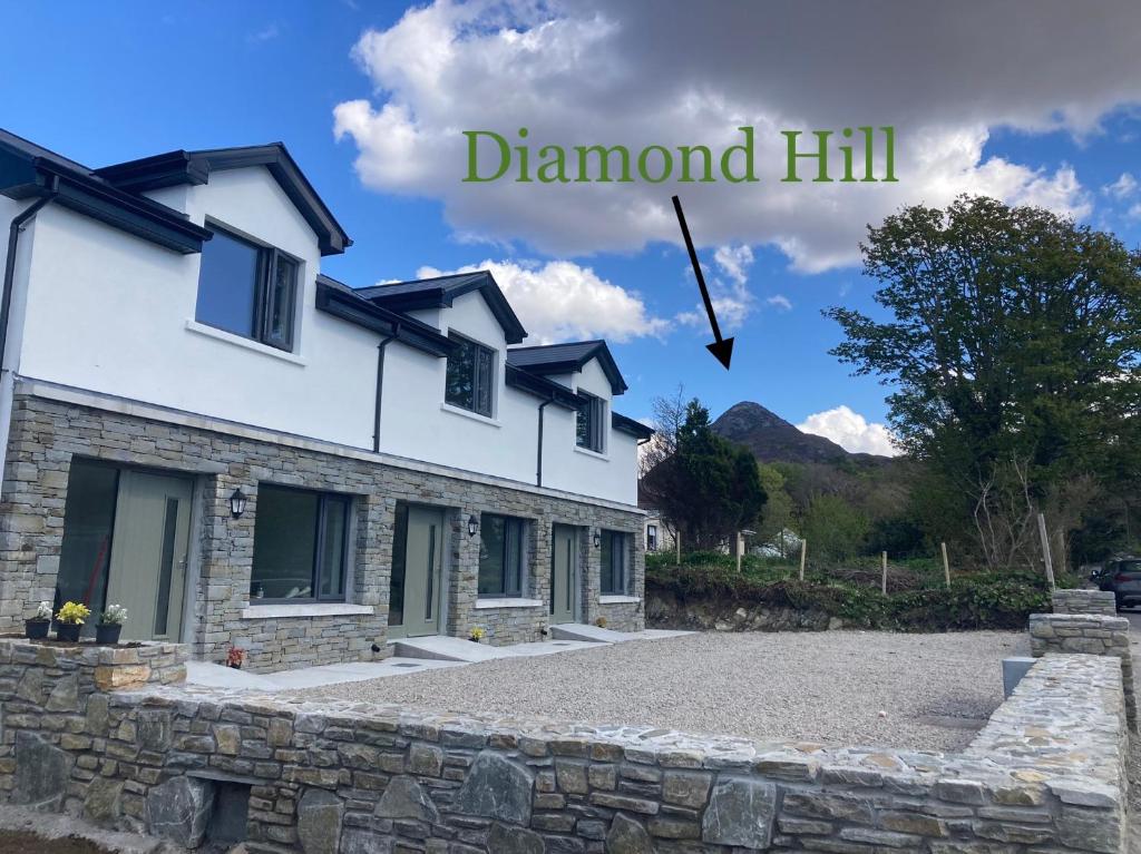 a house with a sign that reads diamond hill at Boutique Townhouses Letterfrack Village - Entrance to Connemara National Park in Galway