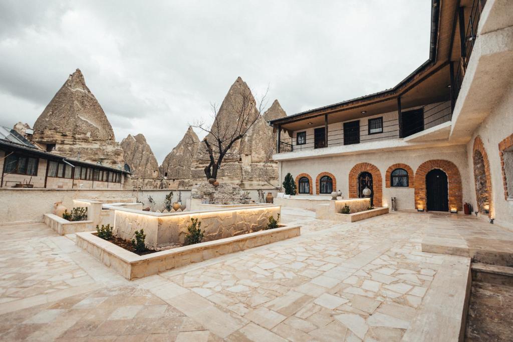 a courtyard of a building with stone buildings at Turan Cappadocia Cave in Goreme