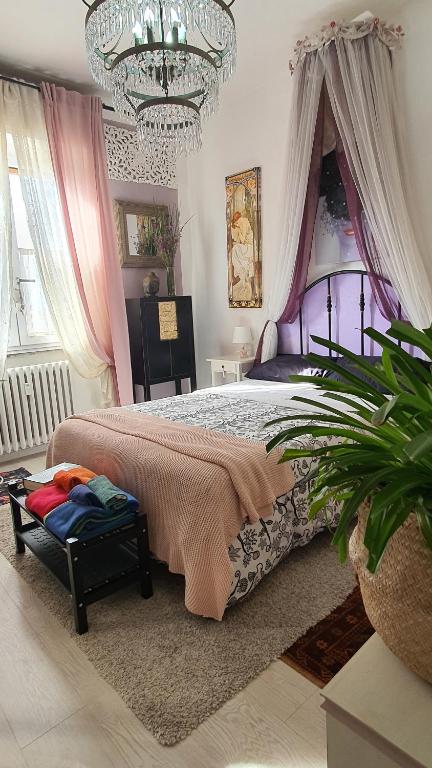 a bedroom with a large bed with a chandelier at Suite in House.. in Florence