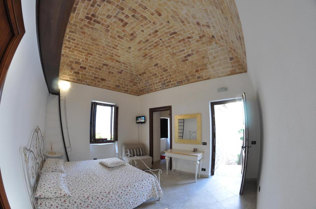 a bedroom with a bed and a brick ceiling at Residenza Lastene in Bovino