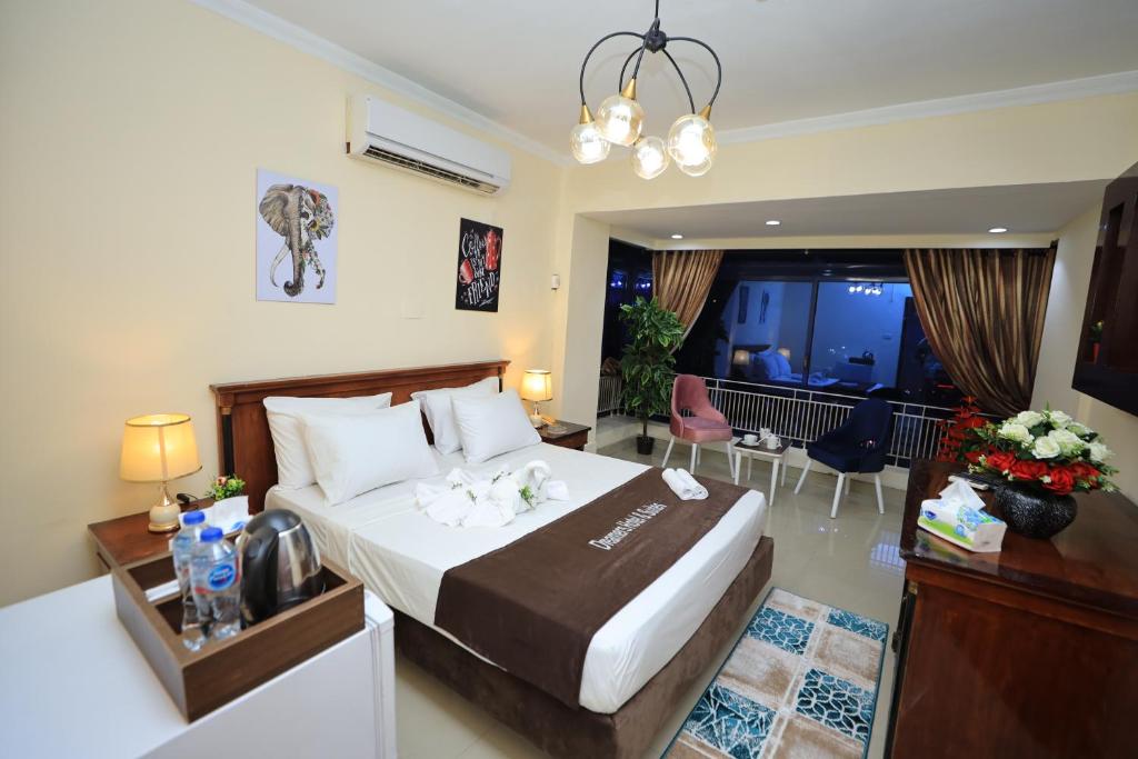 a bedroom with a large bed and a living room at Cairo City Center Dreamers Hotel & Suites in Cairo