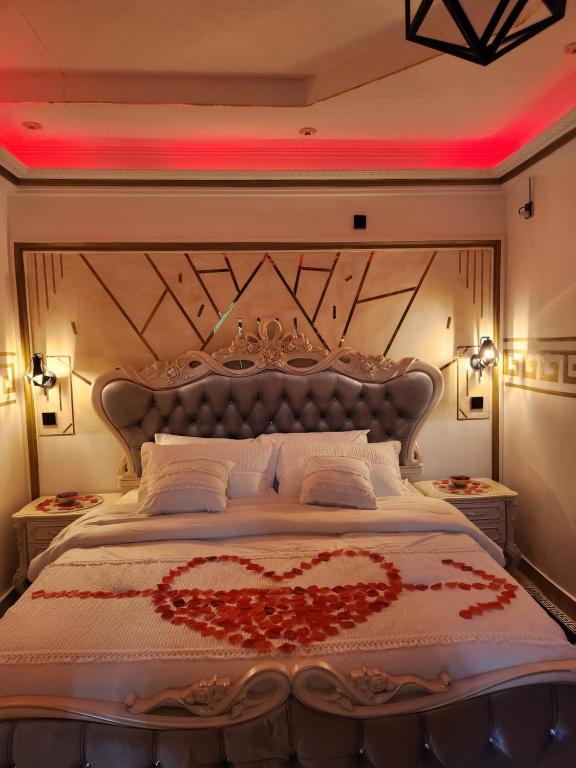 a bedroom with a large bed with a heart design on it at Luxueux platinium in Libreville