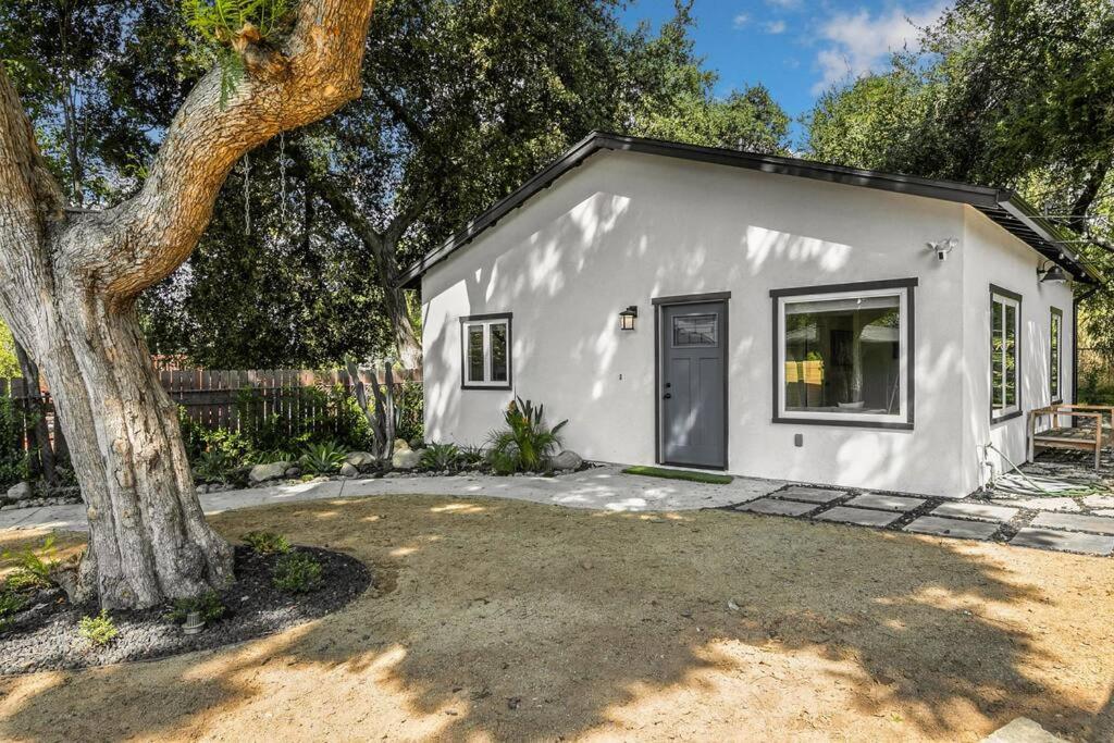a small white house with a tree in front of it at Stylish guest house near colleges in Claremont