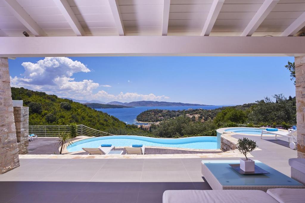 a view of a swimming pool from a house at Villa Tatiana in Ágios Stéfanos