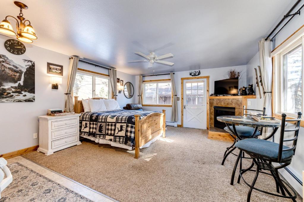 a bedroom with a bed and a desk and a table at Mountain Love Views in Estes Park