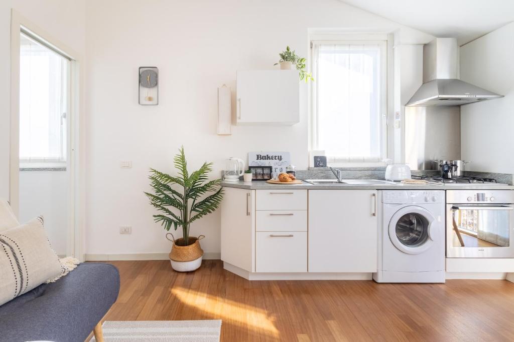 a white kitchen with a washer and dryer at Dream Suite in Como in Como