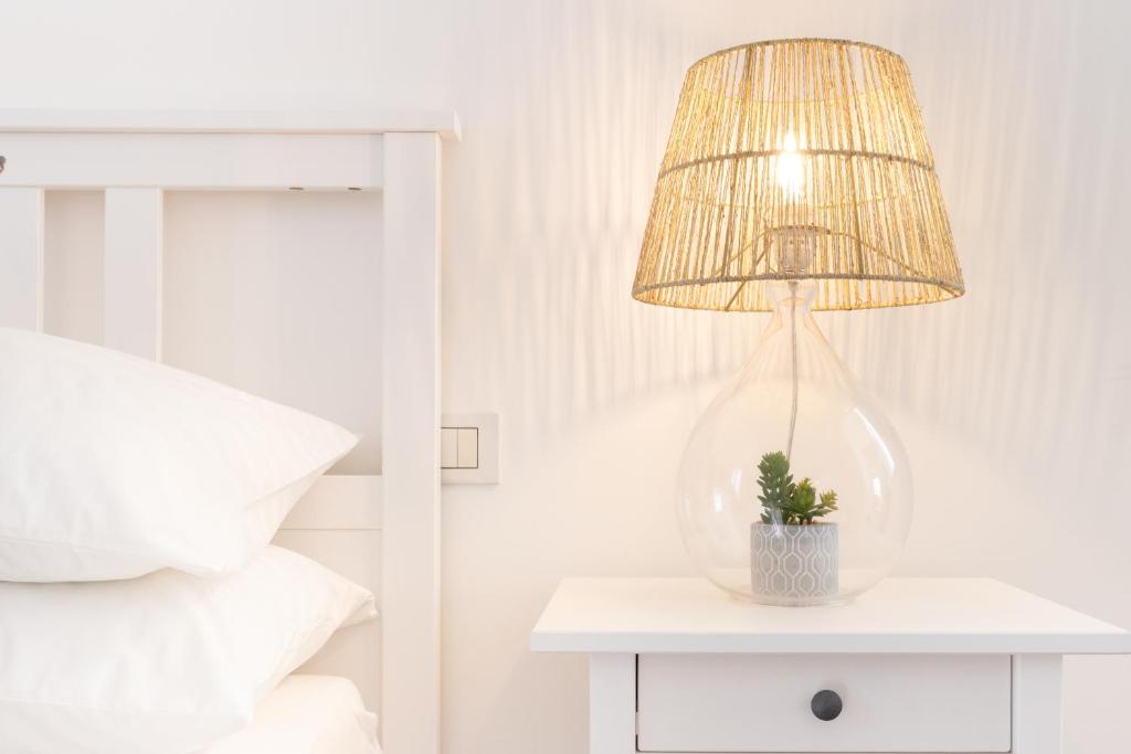 a lamp on a table next to a bed at Dream Suite in Como in Como