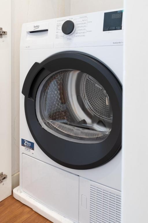 a white washing machine with its door open at Dream Suite in Como in Como