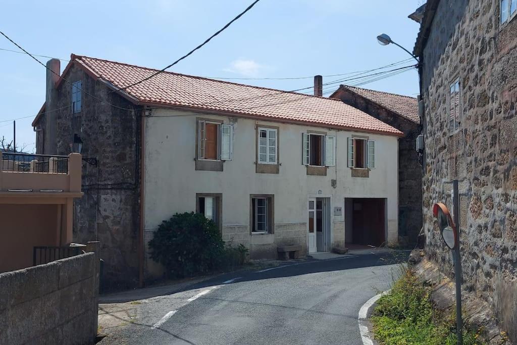 ein Haus in einer Straße neben einem Gebäude in der Unterkunft casa gerente in Muros