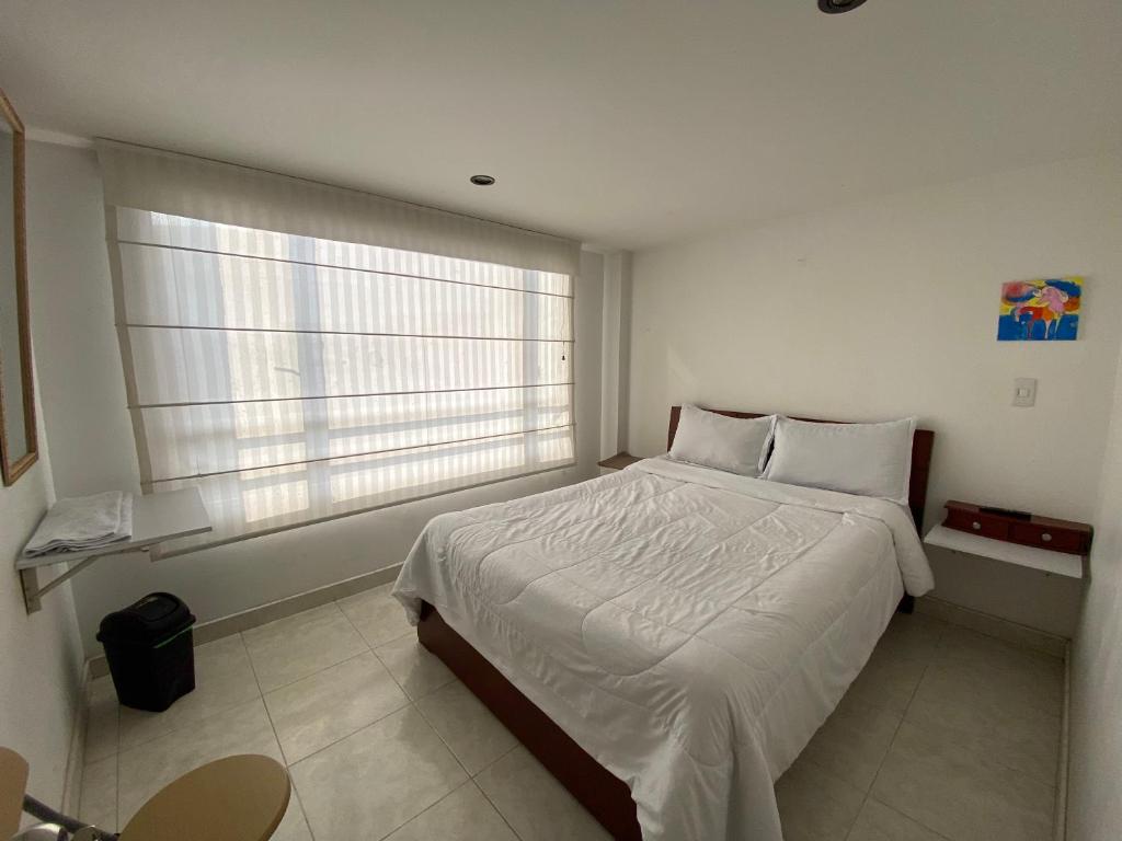 Postel nebo postele na pokoji v ubytování Stay In Bogota