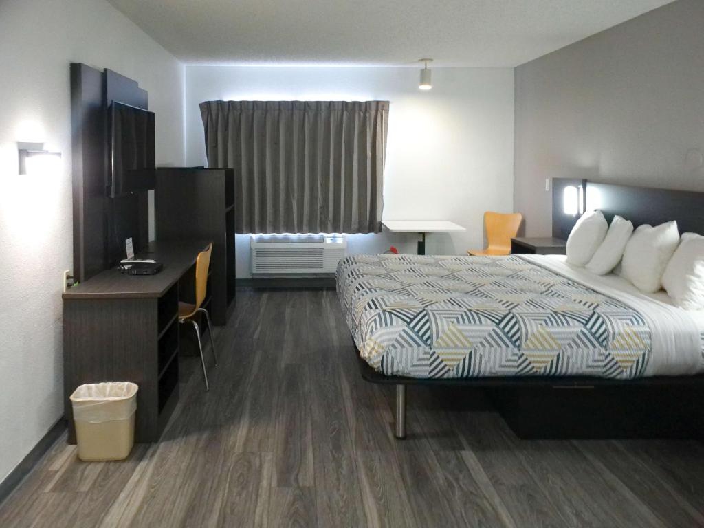 a hotel room with a bed and a desk at Motel 6-Winslow, AZ in Winslow
