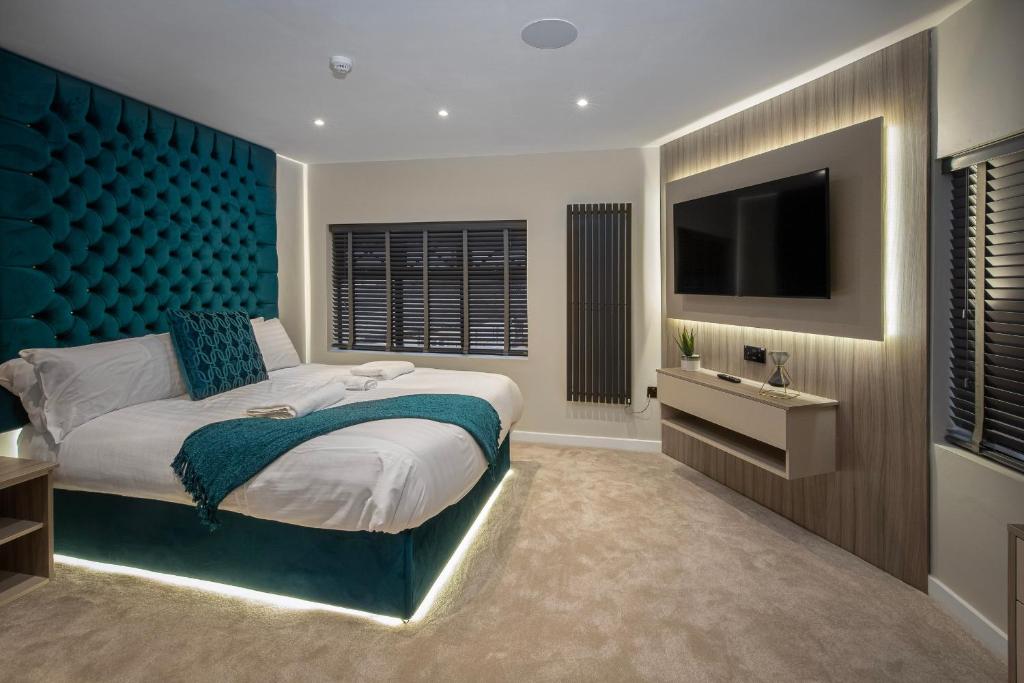 a bedroom with a large bed and a flat screen tv at The Charleston in Blackpool