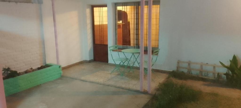 a room with a table and a glass door at Wasi in La Falda