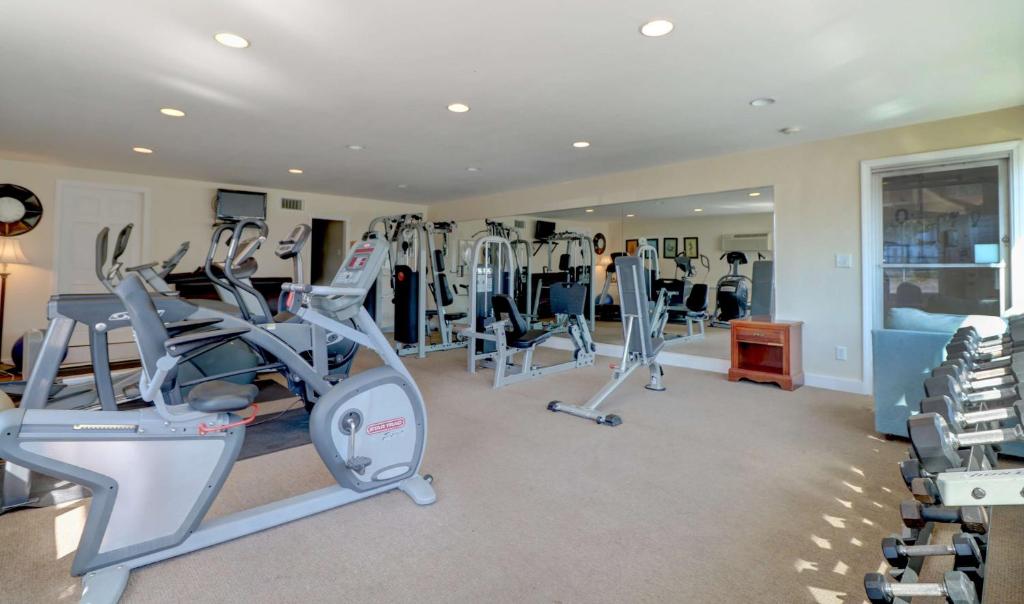 a gym with several treadmills and exercise bikes at Waves Oceanfront Resort in Old Orchard Beach