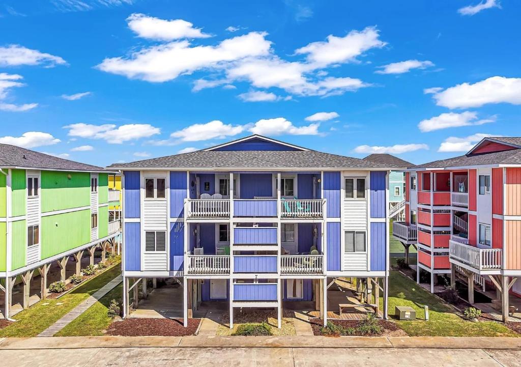 a row of colorful houses in a row at Seven Seas-7C Condo in Holden Beach