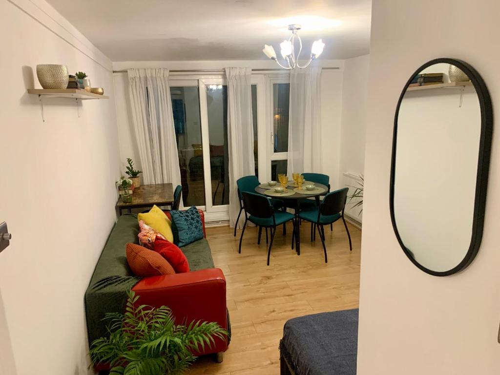 a living room with a couch and a table at Finsbury Park London Apartment - 10 minutes to central London in London