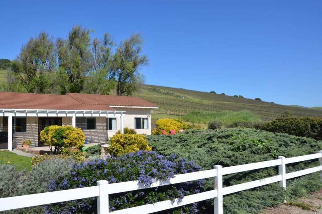 a house with a white fence in front of a garden at Rock 12 Ranch in Buellton
