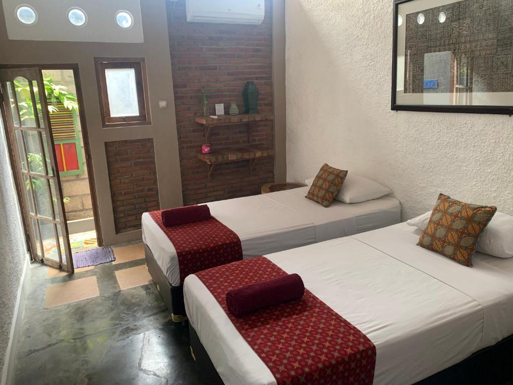 Postel nebo postele na pokoji v ubytování Nextdoor Rooms