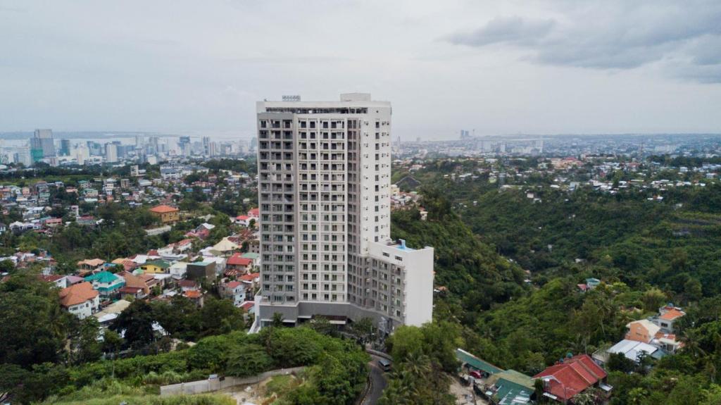 a tall white building on top of a city at Hayat Sky Towers Service Apartment in Cebu City