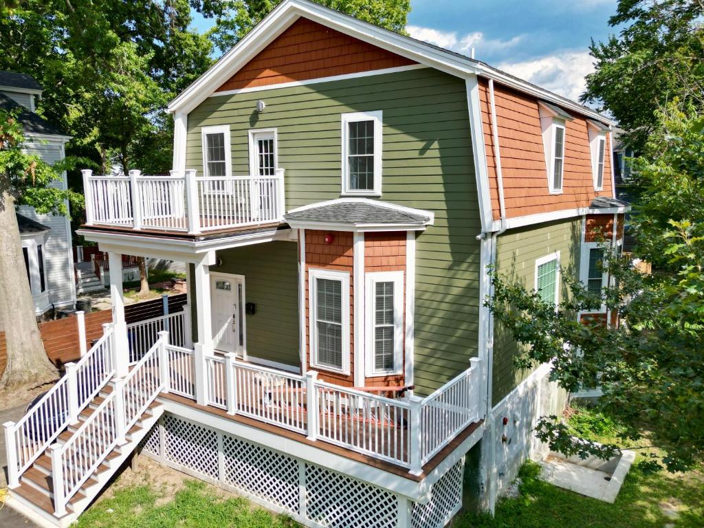 a house with a wrap around porch and a balcony at Perrin Place Unit 3 in Boston