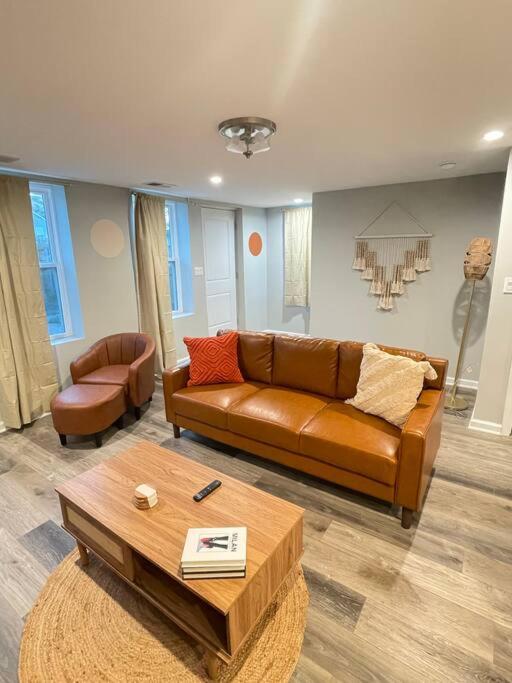 a living room with a brown couch and a table at SPACIOUS & MODERN 3 BR HOME WI-Fi FREE PARKING in Chicago