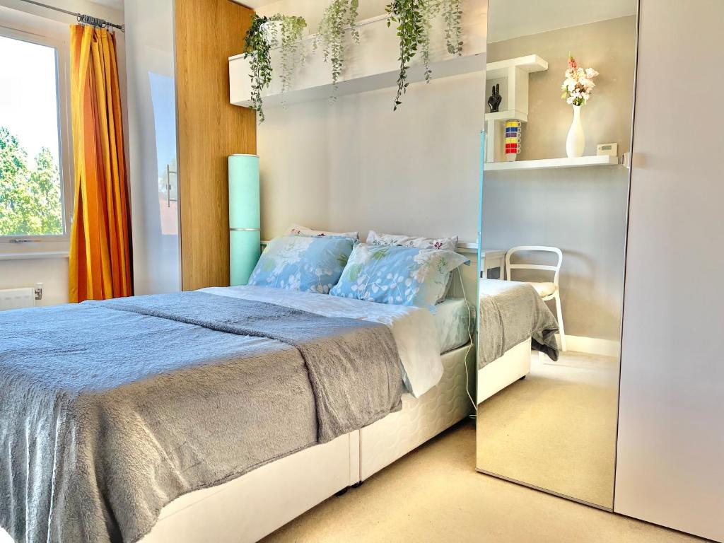a bedroom with a large bed and a mirror at Two bedroom flat with a sofa bed living room in London