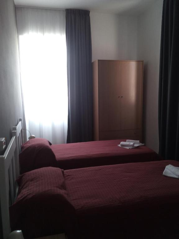 Postel nebo postele na pokoji v ubytování Hotel Piccola Firenze