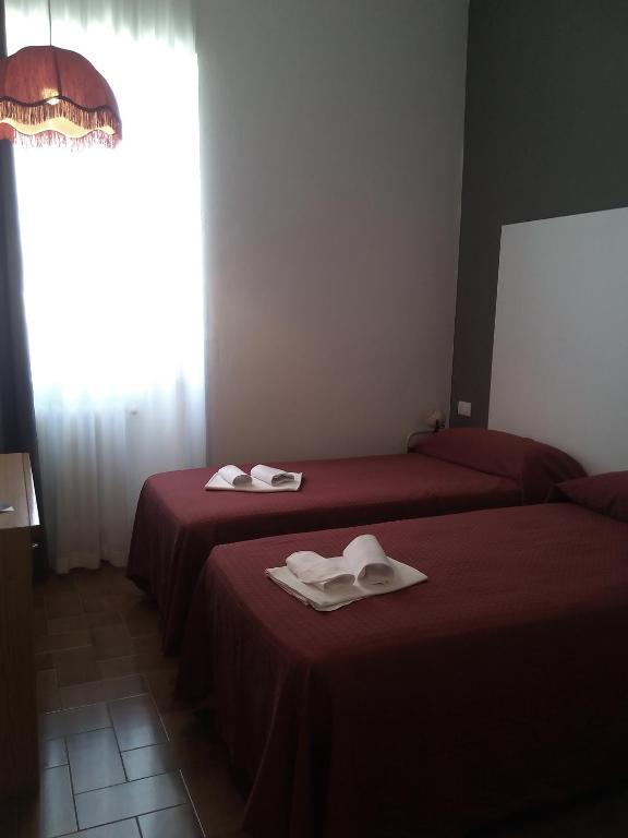 Postel nebo postele na pokoji v ubytování Hotel Piccola Firenze