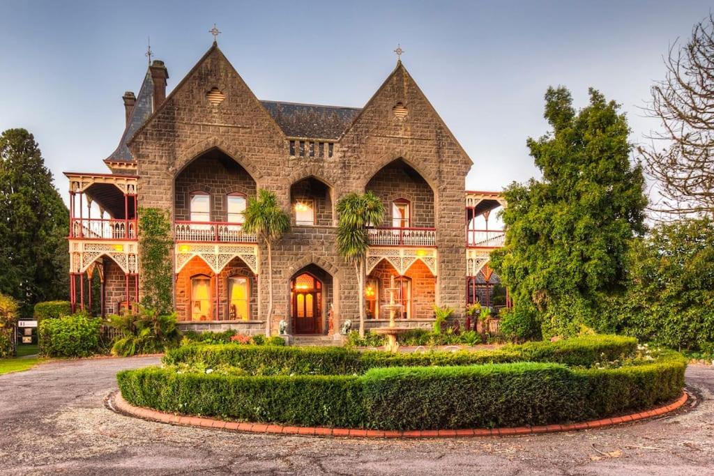 a large house with a garden in front of it at Bishops Palace Ballarat in Wendouree