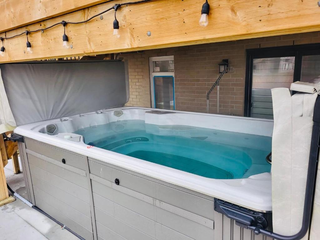 a large jacuzzi tub in a house at Holiday home with all season Swim spa & Pond view in London