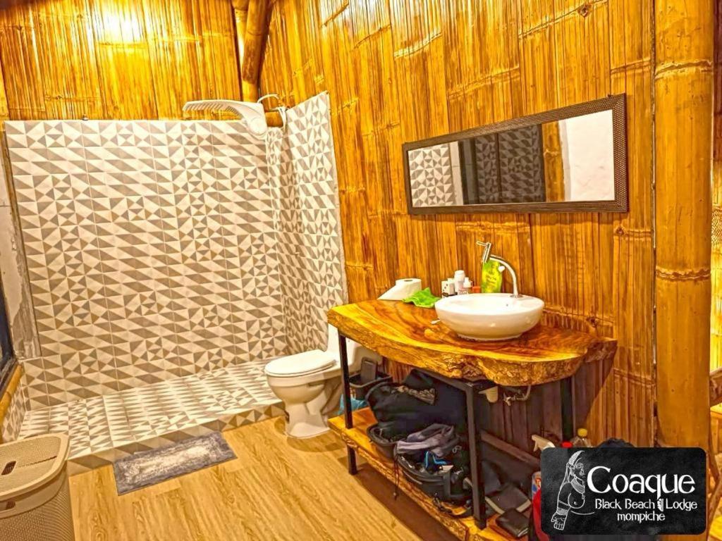 a bathroom with a sink and a toilet at Coaque black Mompiche in Mompiche