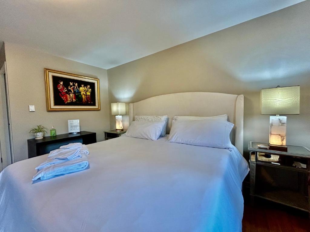 - une chambre avec un grand lit blanc et deux lampes dans l'établissement North Nanaimo Gem - Garden-View Room with Private Ensuite, à Nanaimo