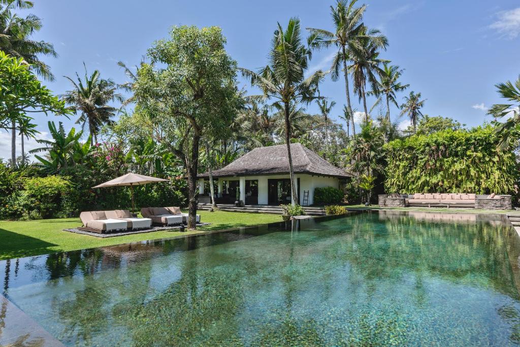 a swimming pool in front of a villa at Villa Florimar - 50m to Seseh Beach in Canggu