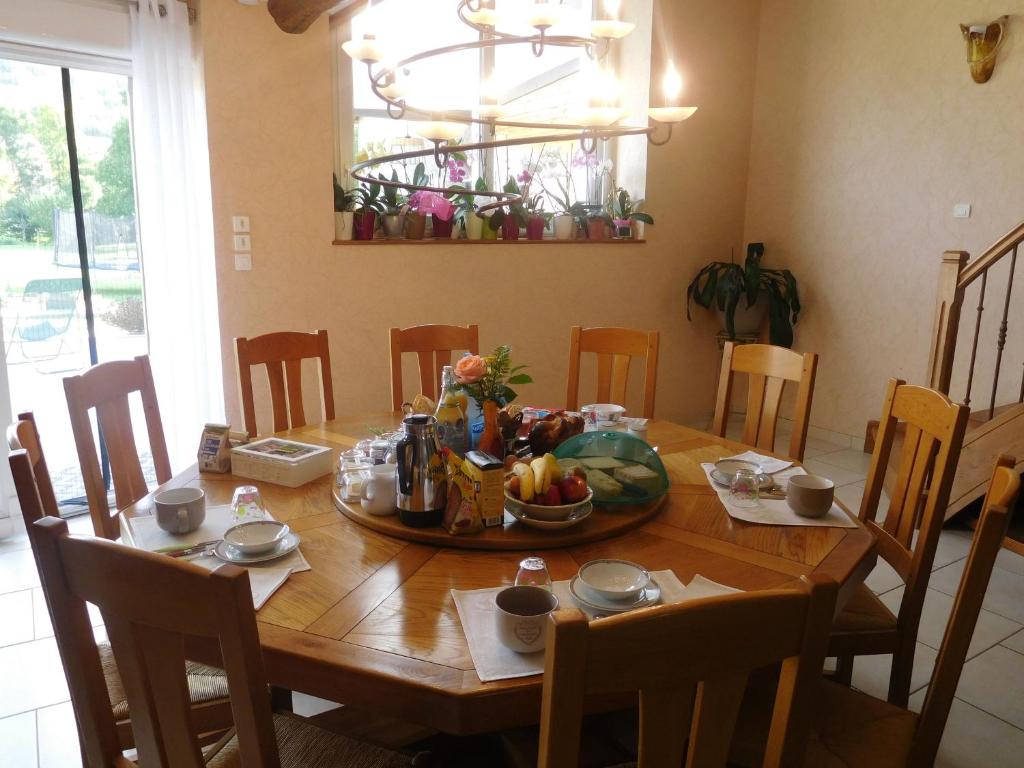 a dining room table with a bowl of fruit on it at Guestroom Arbigny-sous-Varennes, 2 pièces, 4 personnes - FR-1-611-72 