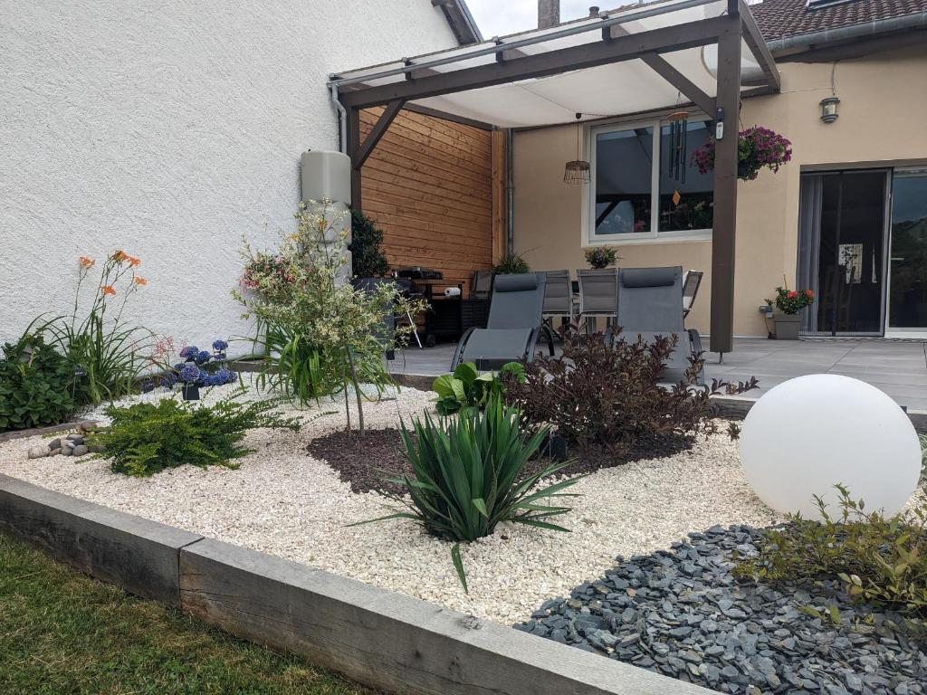 a garden in front of a house with a patio at Guestroom Arbigny-sous-Varennes, 2 pièces, 4 personnes - FR-1-611-72 