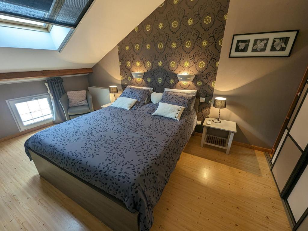 a bedroom with a large bed with blue sheets and pillows at Guestroom Arbigny-sous-Varennes, 2 pièces, 4 personnes - FR-1-611-72 