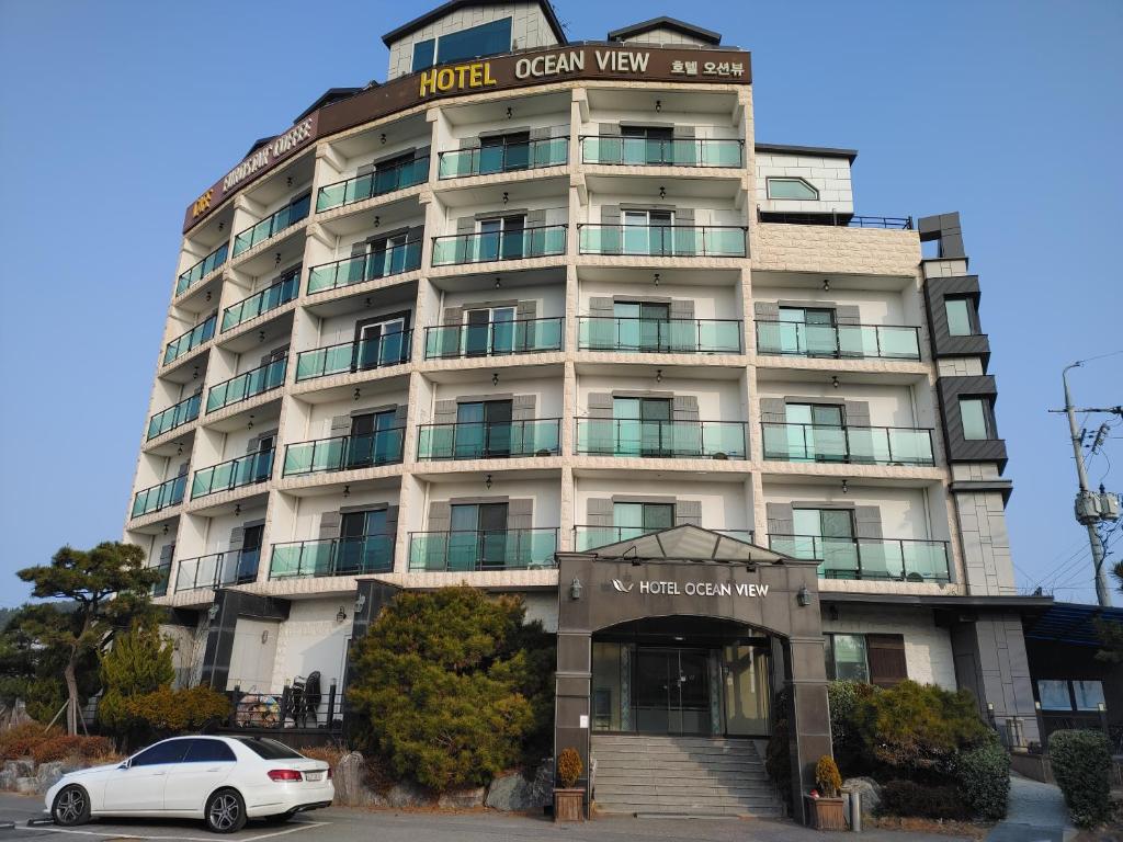 a white car parked in front of a building at Hotel Oceanview in Incheon