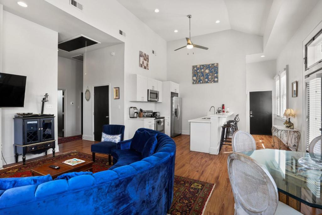 a living room with a blue couch and a table at Stunning 2-Bedroom Garden District Newly Renovated in New Orleans