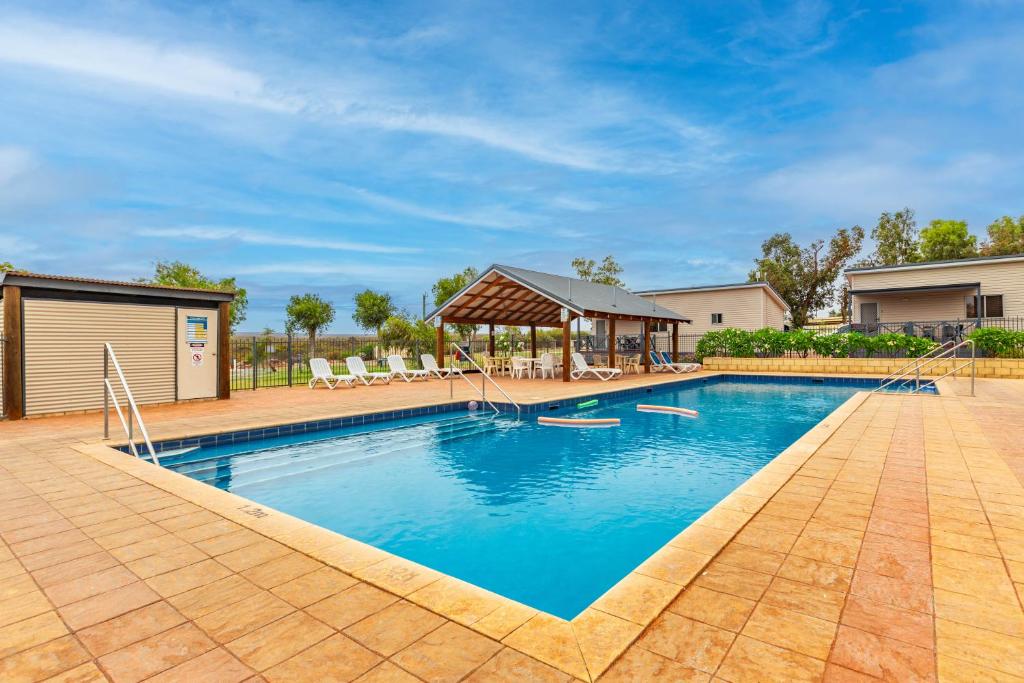 a large swimming pool with a gazebo at Kalbarri Tudor Holiday Park in Kalbarri